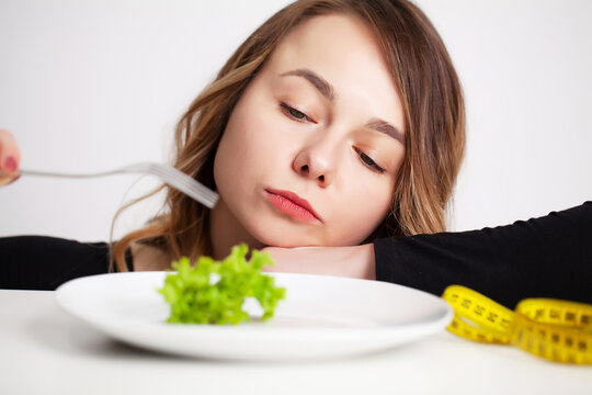 Young woman holding green broccoli, healthy way to lose weight