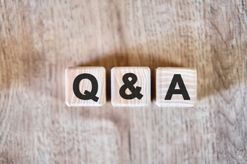Fototapeta premium Questions and answer - text on wooden cubes, on wooden background