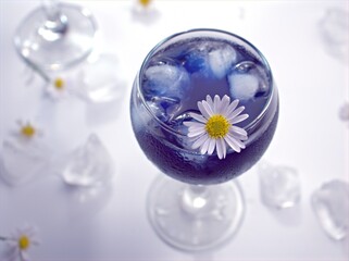 Closeup white common daisy flowers in purple hrab ice tea with bright blurred background ,macro image ,soft focus ,healthy drinking