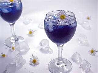 Closeup white common daisy flowers in purple hrab ice tea with bright blurred background ,macro image ,soft focus ,healthy drinking