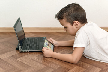 boy uses a laptop