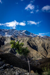 Fototapeta premium Tichka - Mountain road through the Tizi-n-Tichka pass in the Atlas Mountains, Morocco. This mountain pass is connecting Marrakesh to the city of Ouarzazate.