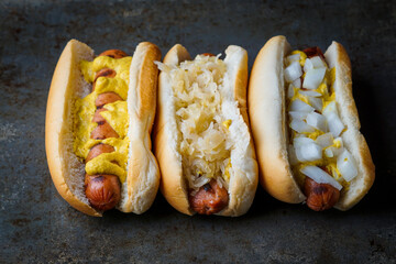 Grilled hot dogs with mustard, sauerkraut and onions