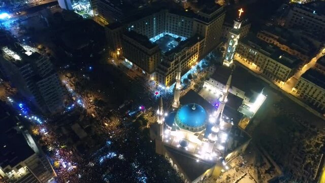 Beirut, Lebanon 2019 : night drone top shot of Martyr square, during the Lebanese revolution, with thousands of protesters revolting against government failure and corruption