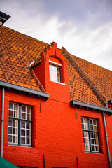 It's Medieval houses with flowers at the windows in the Historic Centre of Bruges, Belgium. part of the UNESCO World Heritage site