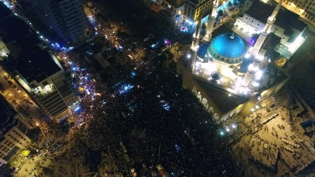 Beirut, Lebanon 2019 : night drone top shot of Martyr square, during the Lebanese revolution, ped down on thousands of protesters revolting against government failure and corruption