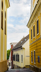 Fototapeta na wymiar It's Narrow street between the yellow houses