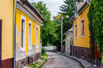 Fototapeta na wymiar It's Narrow street between the yellow houses