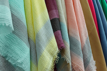 Fabrics with fringe. Colors - aquamarine, yellow, burgundy, orange. Gray stripes. Concept - tissue shop.