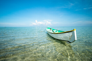 traditional boat in shallow sea water