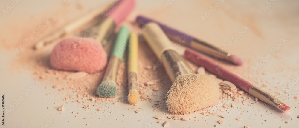 Wall mural make up brushes with powder on white background