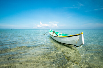 traditional boat in shallow sea water