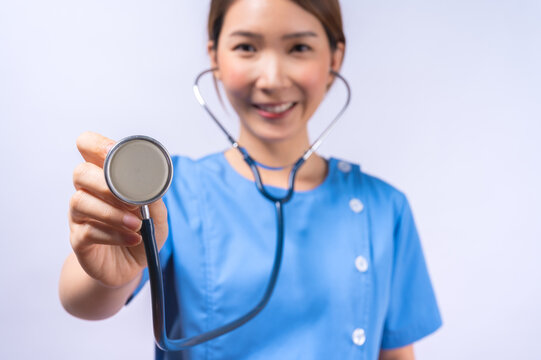 Portrait of smiling Asian nurse with stethoscope isolated on white background