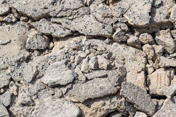 Broken Road crack Texture. After Construction drilled surface with jackhammer. Concrete broken from excavator drilling. The road was dug and drilled to create drainage ditches.