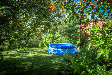 Inflatable blue pool in the backyard of a private house.