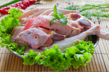 Cut up raw whole chicken in a plate close up