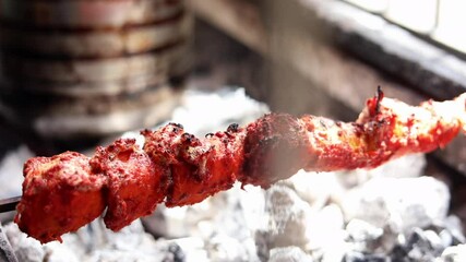 Making masala soya chaap tikka with onions and green mint chutney, served on a white plate.