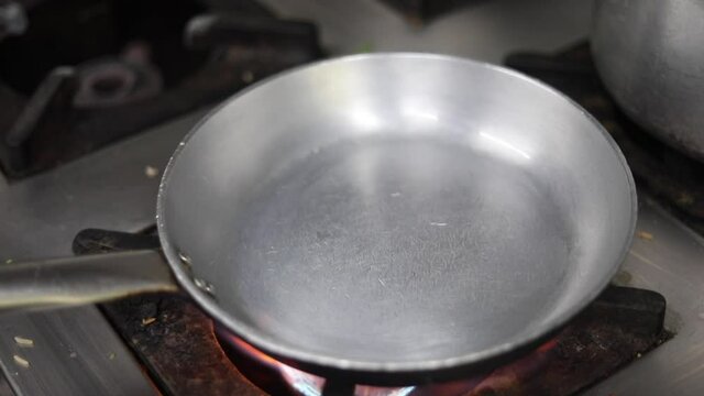 Cooking red sauce, with sauteed vegetables, caramelised onions, red chillies and capsicum on a hot oil pan.