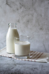 Fresh organic milk in a glass and a bottle