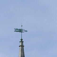 weather vane against a blue sky