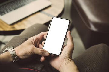 cell phone mockup image blank white screen.man hand holding texting using mobile on desk at coffee shop.background empty space for advertise.work people contact marketing business,technology