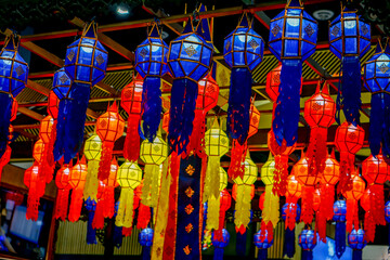 Closeup and look up view of decorated Thai Lanna style lanterns to hang on hotel lobby ceiling background with open lights on
