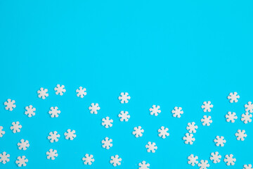 Fototapeta na wymiar background, sweet topping for a cake in the shape of a snowflake on a blue background, copy space