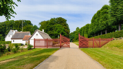Small houses and the red fence in the park behind the Castle in Denmark