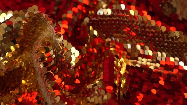 Gold and red sequin texture. Fashion luxury fabric glitter, spangles, paillettes. Holiday abstract glitter background with blinking lights