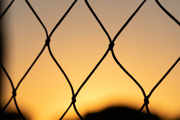 barbed wire fence at sunset