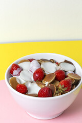 Homemade cereals mini pancake with yogurt, honey and strawberries on colorful background.