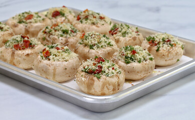 Stuffed Mushrooms on a baking sheet ready to bake with selective focus on front mushroom.