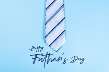 Happy Father Day background concept with blue necktie on blue background with copy space for text.