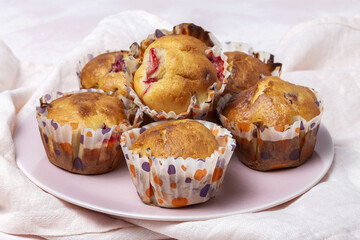 Homemade muffins with red berries and cherries