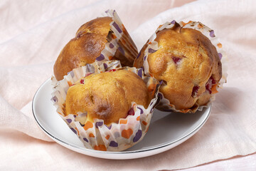 Homemade muffins with red berries and cherries