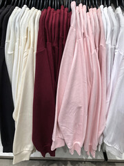 Women's clothing on a hanger in the store - coats, jackets, blouses
