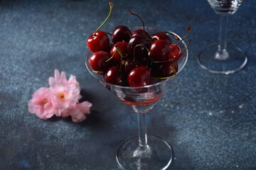Sweet red and yellow cherries in two glasses. Cherry close-up in a glass with water drops. Summer sweet dessert