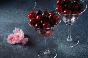 Sweet red and yellow cherries in two glasses. Cherry close-up in a glass with water drops. Summer sweet dessert