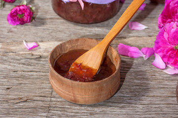 Homemade tea rose petal jam on a old wooden table