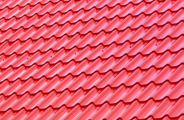 Red metal tile on the roof of the house