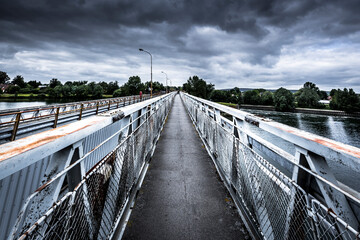 Large view by wide angle on bridge over the Seine River in France, metallic construction.