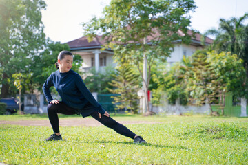 Fototapeta premium Portrait of Asian woman workout before running at village park.