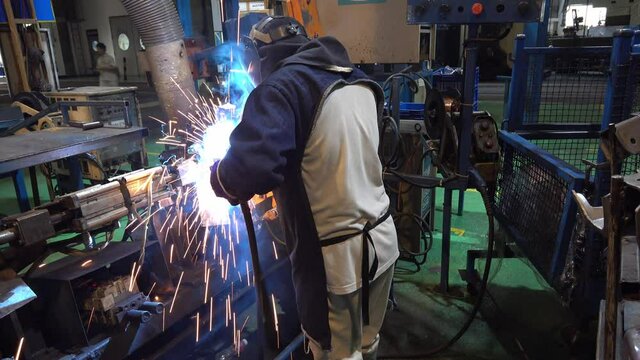 welder works at a part of the car factory.