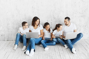 Large family with gadgets. Children and parents at home with a laptop. 