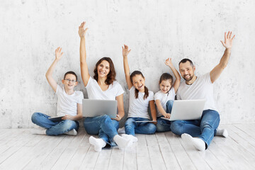 Large family with gadgets. Children and parents at home with a laptop. 