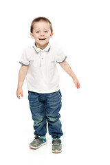 Studio portrait of funny little and sweet boy,wearing in white polo and jeans playing, jumping, dancing at studio. Cute child happy smiling at camera. Stylish kids look. White background.