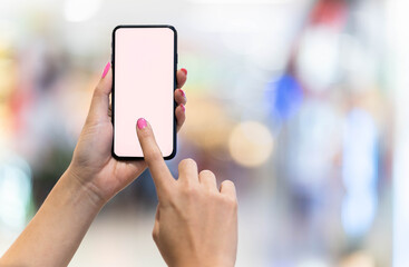 woman holding smartphone with message blurred store background.