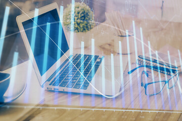 Forex market chart hologram and personal computer background. Double exposure. Concept of investment.