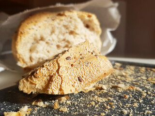 A piece of bread in the morning light. Breakfast with fresh bread.