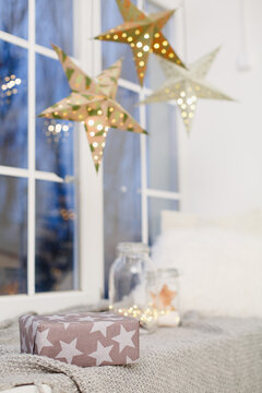 window in a room decorated for celebrating Christmas. Scandinavian interior in white colors. Gift baxes for Christmas presents